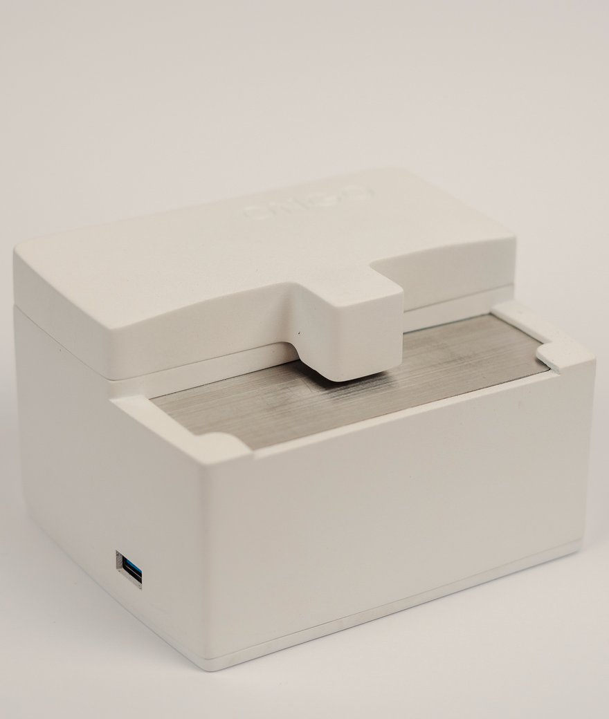 Ongo Vision analyser assembled by Gelco: white moulded enclosure, lid slid open over a machined steel slide tray