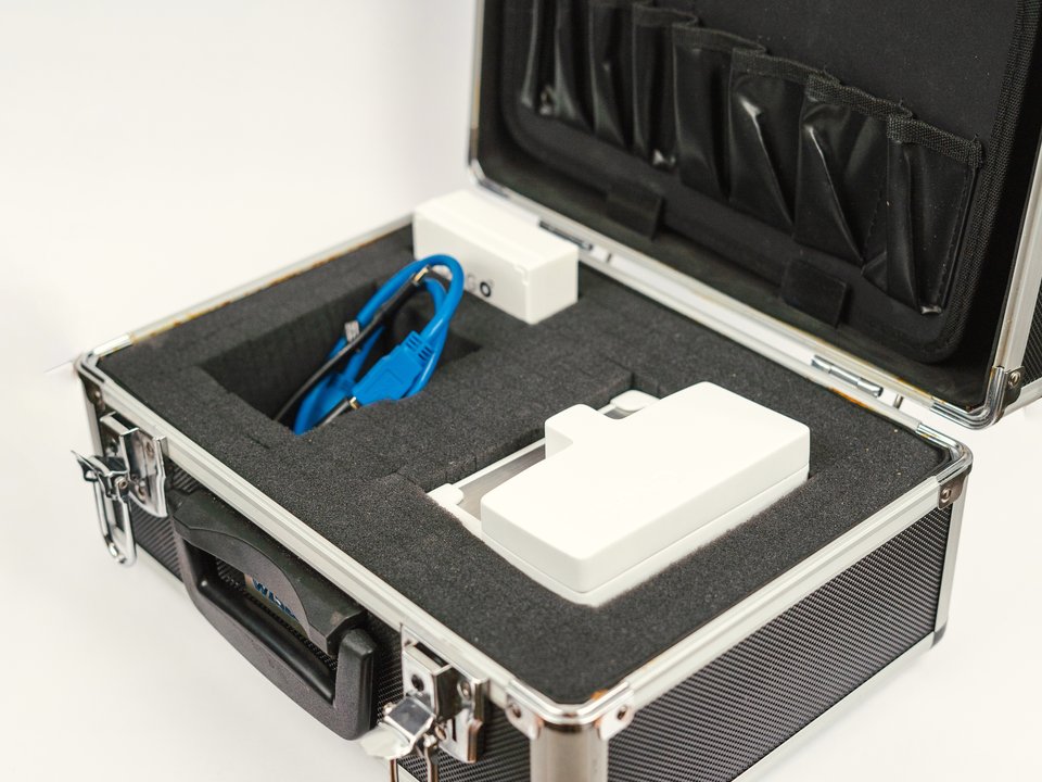 Ongo Vision analyser and cable seated in cut foam inside its flight case, ready to ship